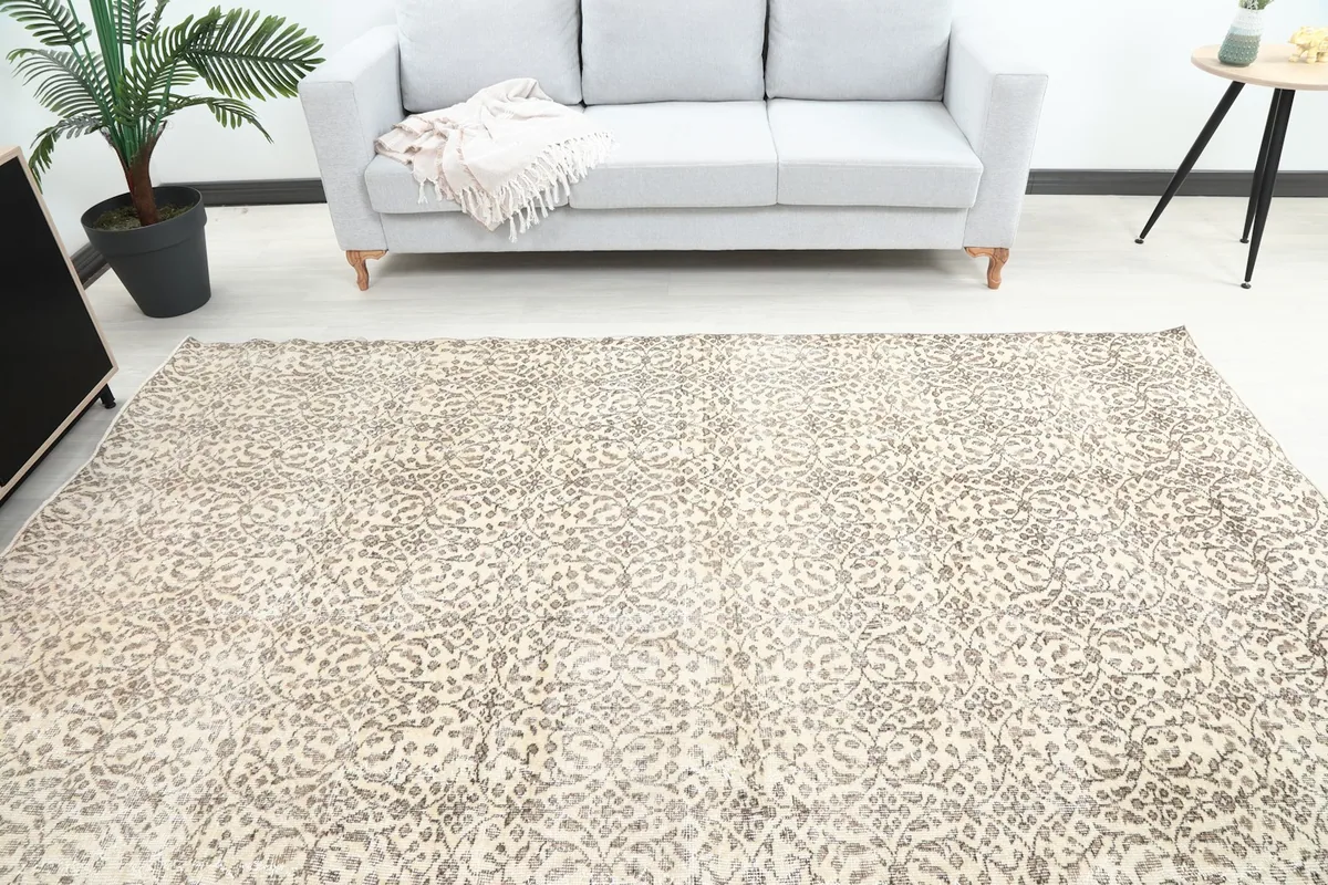 Overhead view of the vintage rug in a living room, showing its full spread