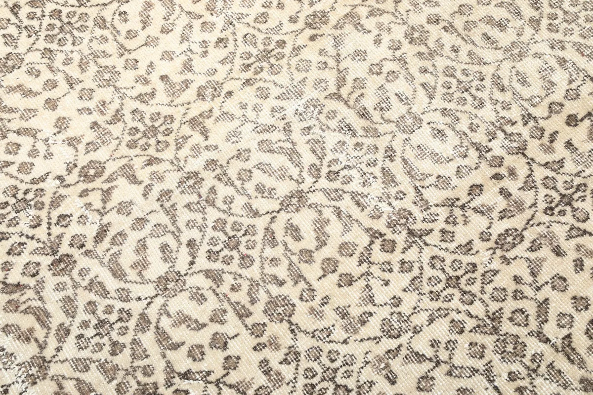 Close-up showing the intricate floral motifs and texture of the wool pile