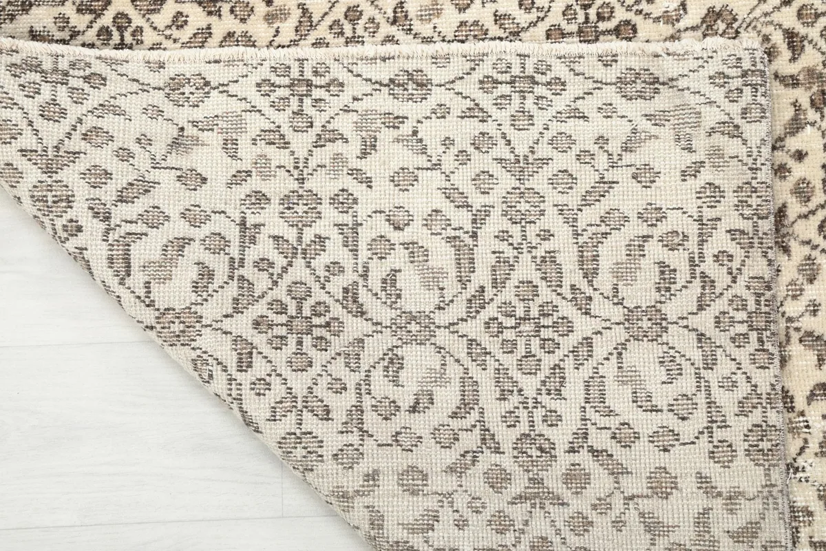 Underside of the rug, revealing the cotton foundation and hand-knotted construction
