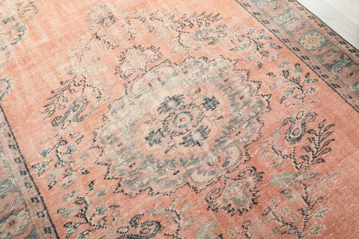 Detailed view of the central medallion and floral patterns on the rose field
