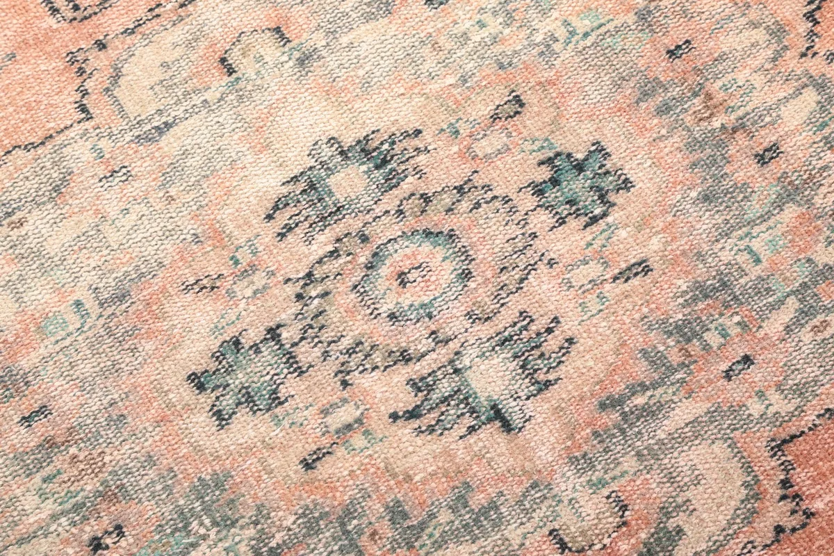 Close-up showing the low pile texture and intricate knotting of the rug's patterns