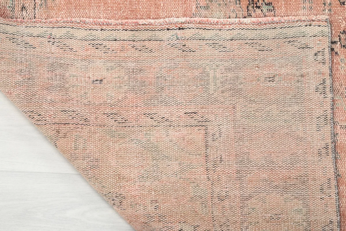 Detailed view of the back of the hand-knotted rug, revealing the foundation and knot work