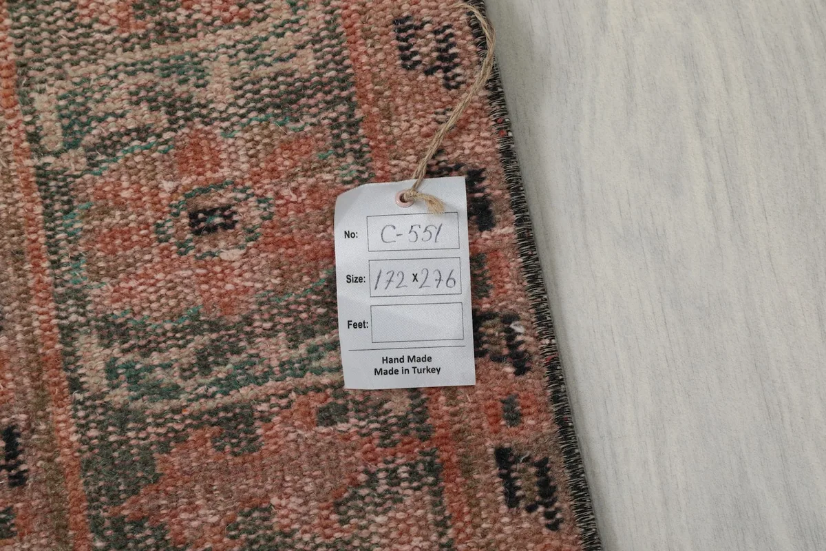 Tag attached to the rug displaying the size in centimeters and indicating it's handmade from Turkey