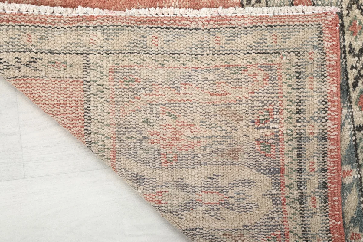 Close-up of the back of the rug, revealing the tight hand-knotted wool on cotton foundation