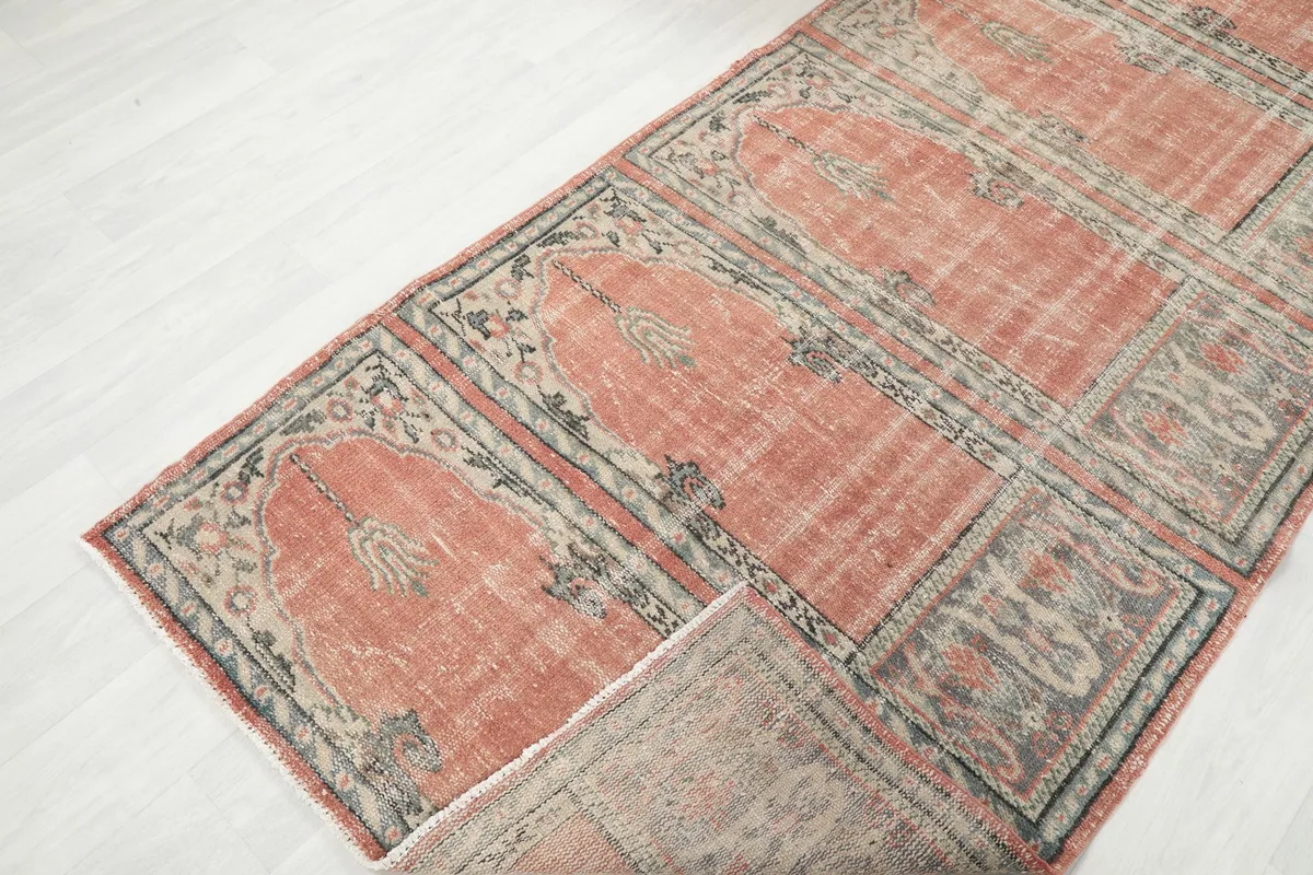 View of the rug folded back to show the reverse side and the hand-knotted construction