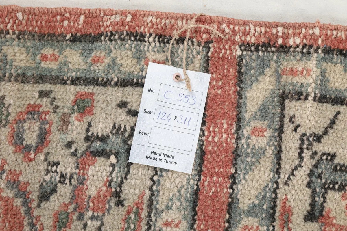 Close-up of the care tag attached to the rug, showing size and origin information
