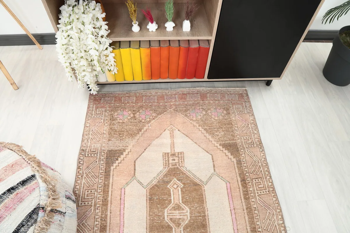 Top-down view of the runner rug's design near furniture, emphasizing the color variations and tribal motifs