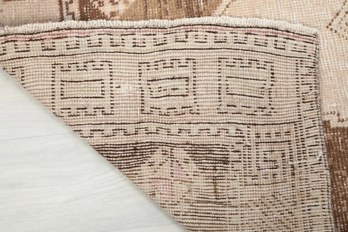 Close-up of the back of the hand-knotted rug, revealing the cotton foundation and knotting detail