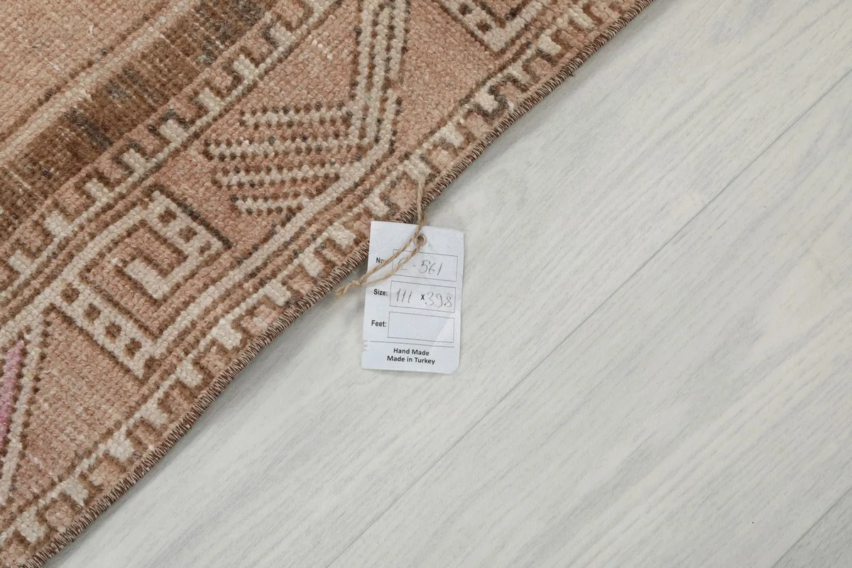 Corner of the rug with a product tag, indicating its origin and material specifications