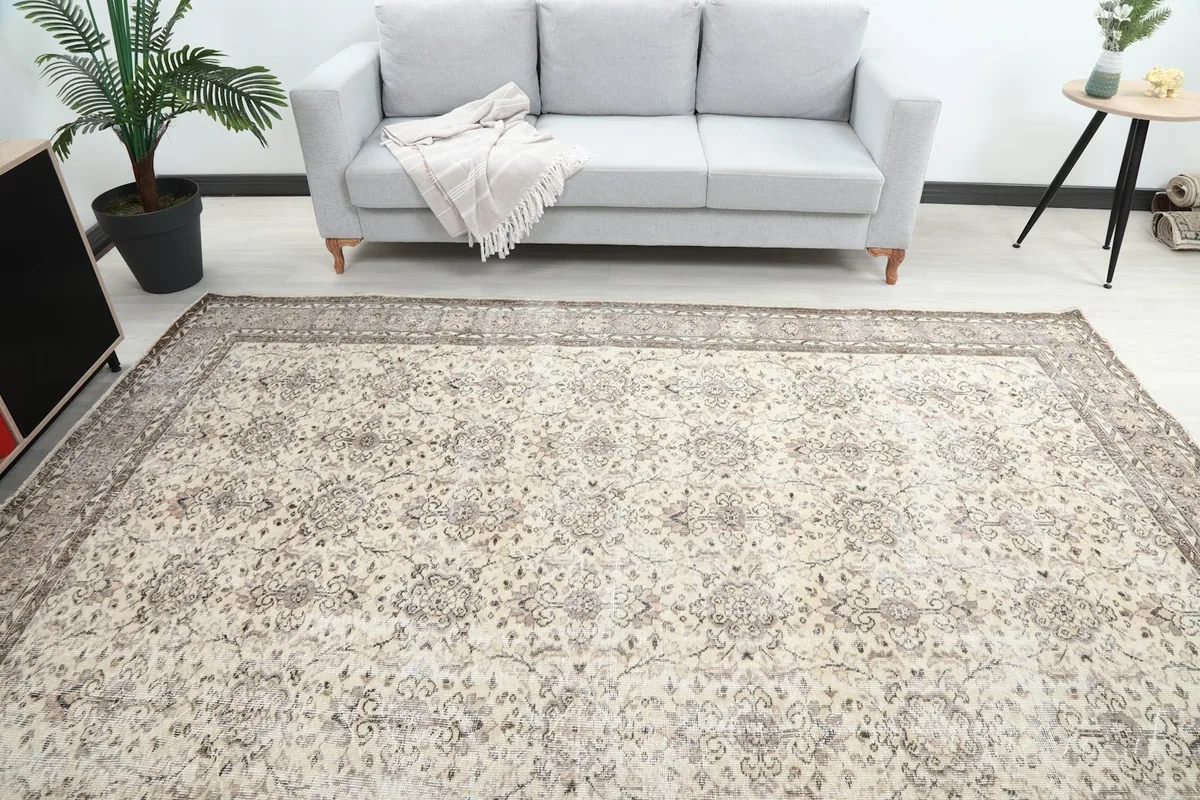 Overhead view of the ivory and gray rug in a living room, highlighting the full pattern and colors.