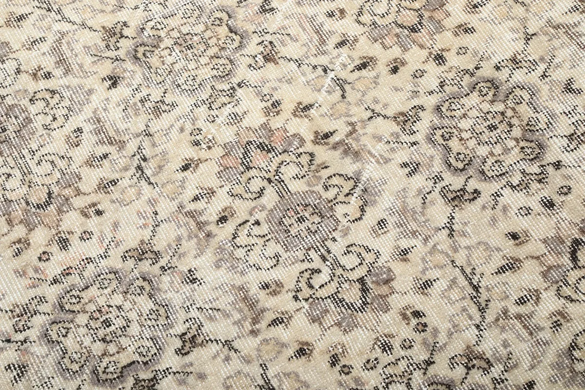 Detailed view of the hand-knotted wool pile, revealing the intricate floral and geometric patterns.