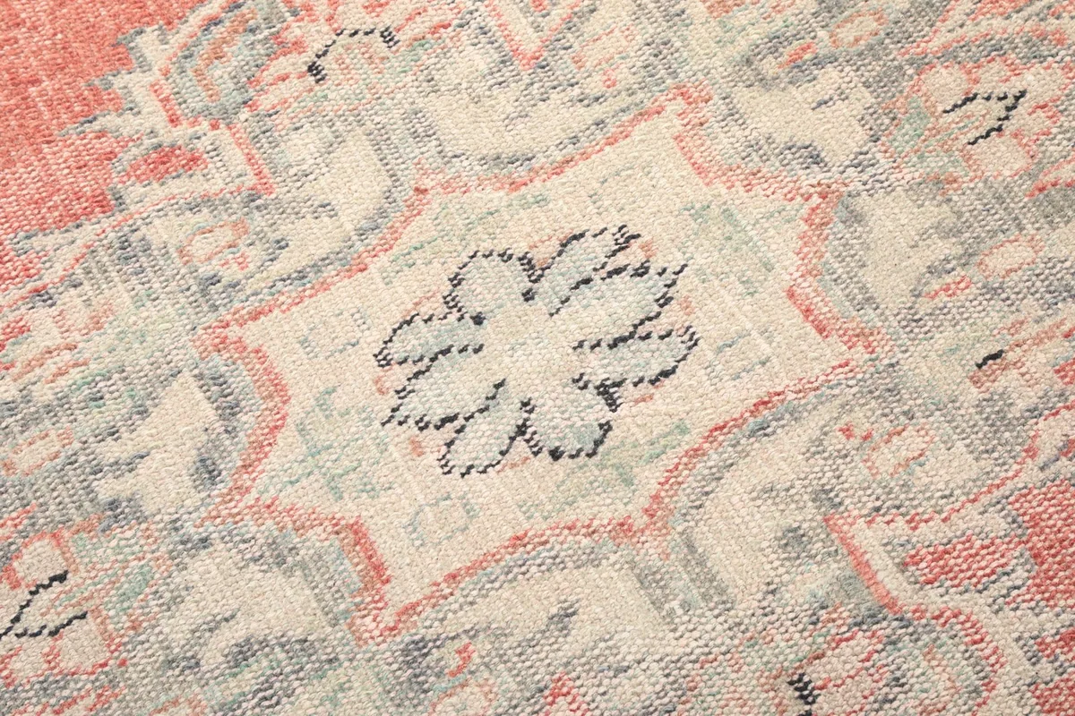 Detailed view of the intricate knotting and color variations within the rug's central motif