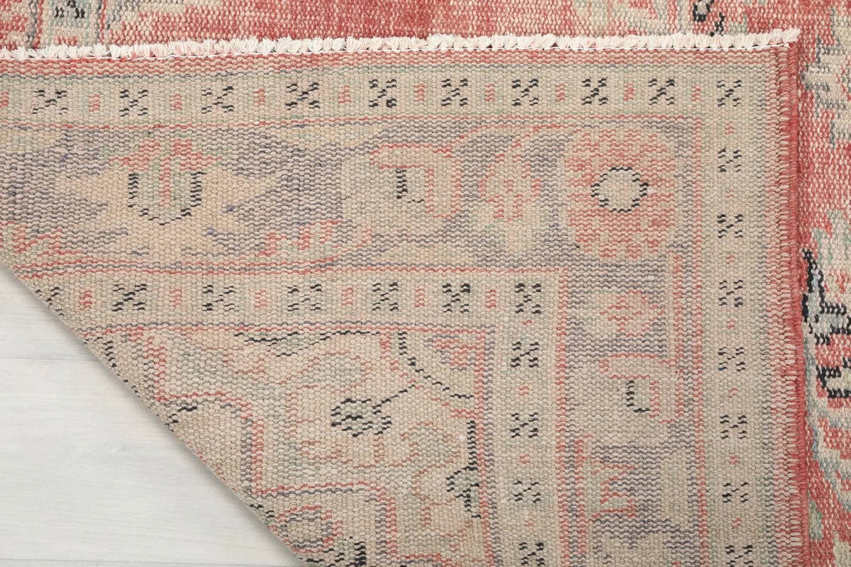 Detailed view of the rug's reverse side, revealing the hand-knotted wool pile on a cotton foundation