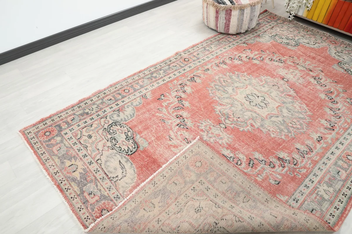View of the rug with a corner folded back, showing the cotton foundation and the reverse side of the knots