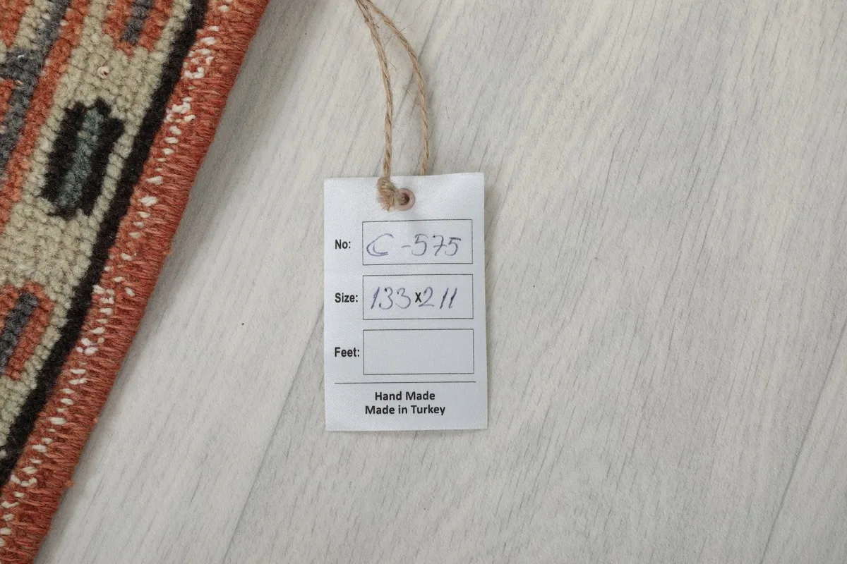 Product tag displaying the rug's unique item number, size in centimeters, and origin.
