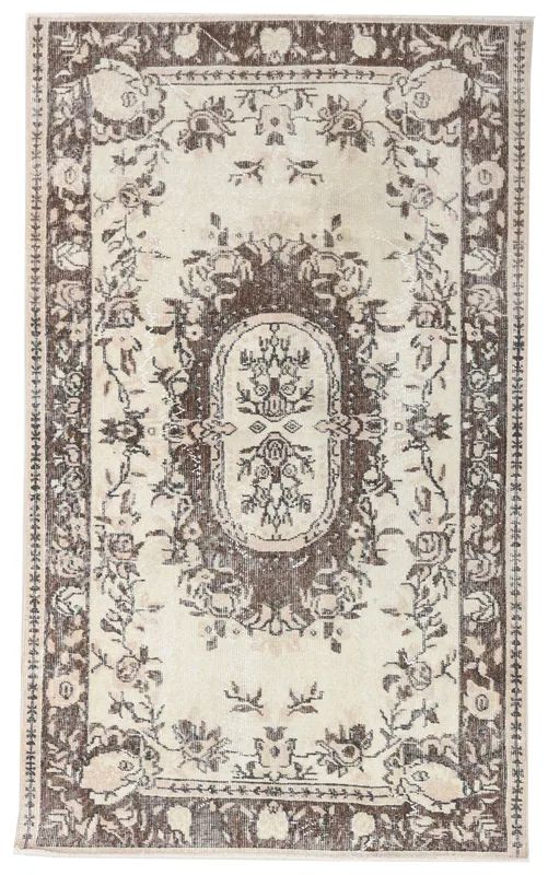 Full overhead view of the 3'8" x 6'2" vintage Anatolian rug with ivory field and brown floral design.