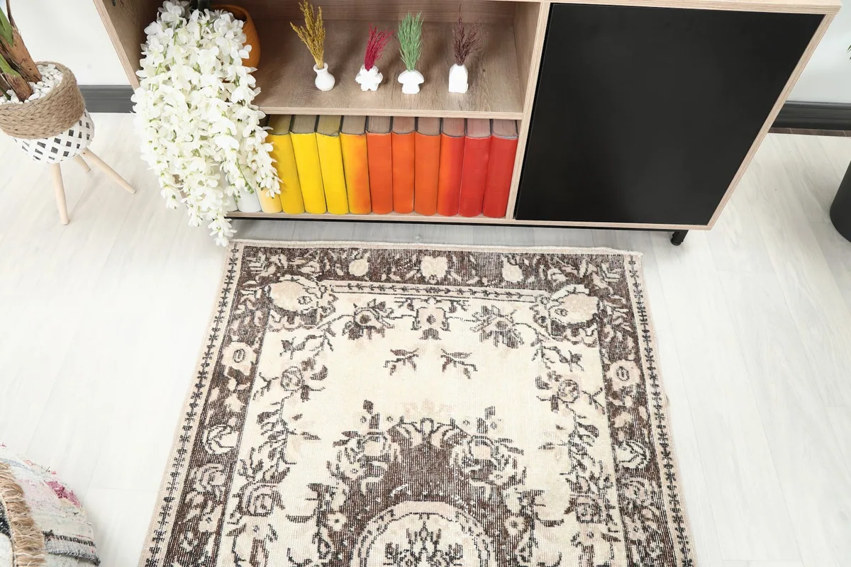 Detailed angle view of the rug's top half, capturing the floral motifs and color variations.