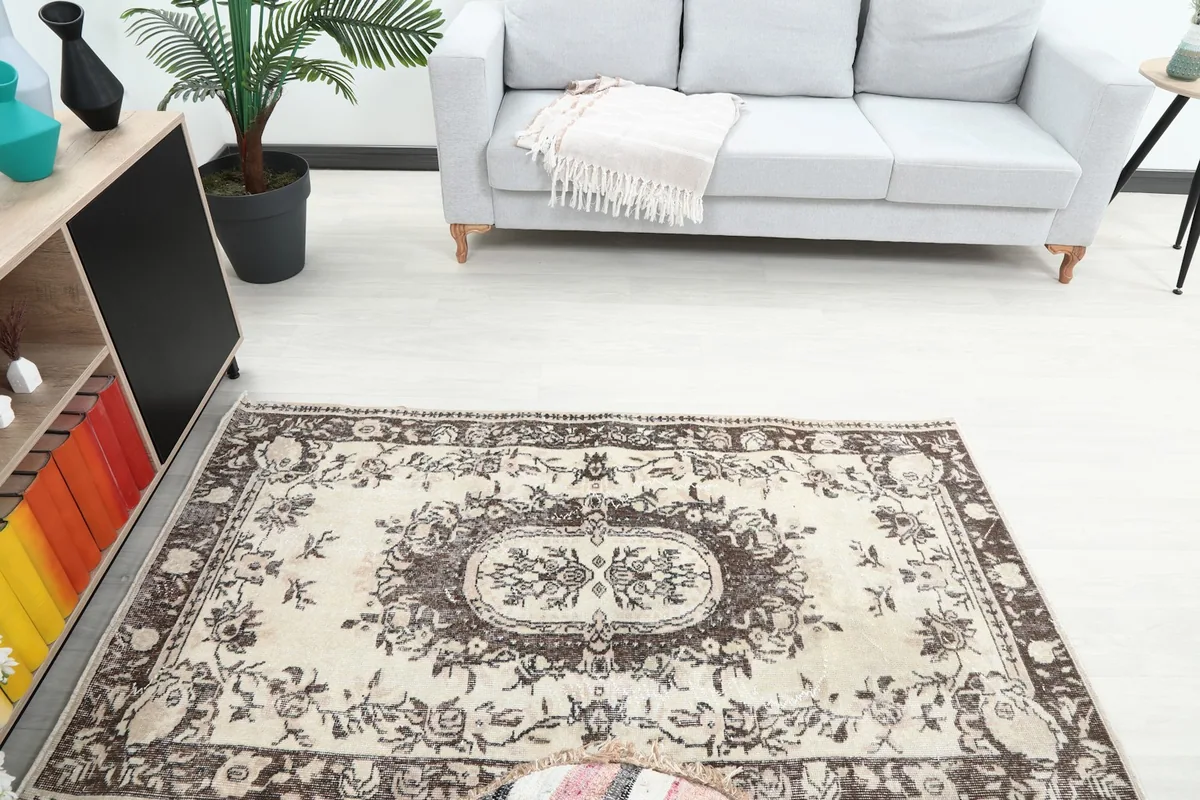 Overhead view of the rug in a room, showing its placement in front of a light gray sofa.