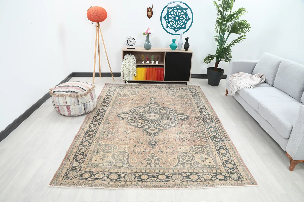 Faded Rust Medallion Anatolian Rug in a living room setting, showcasing its size and colors with a gray sofa.
