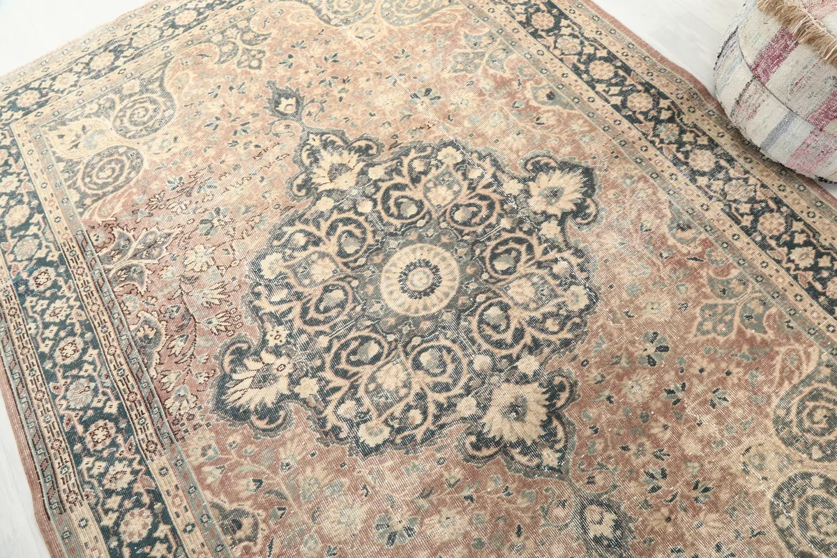 Angled view of the Faded Rust Medallion Anatolian Rug's central medallion and surrounding field, showing texture.