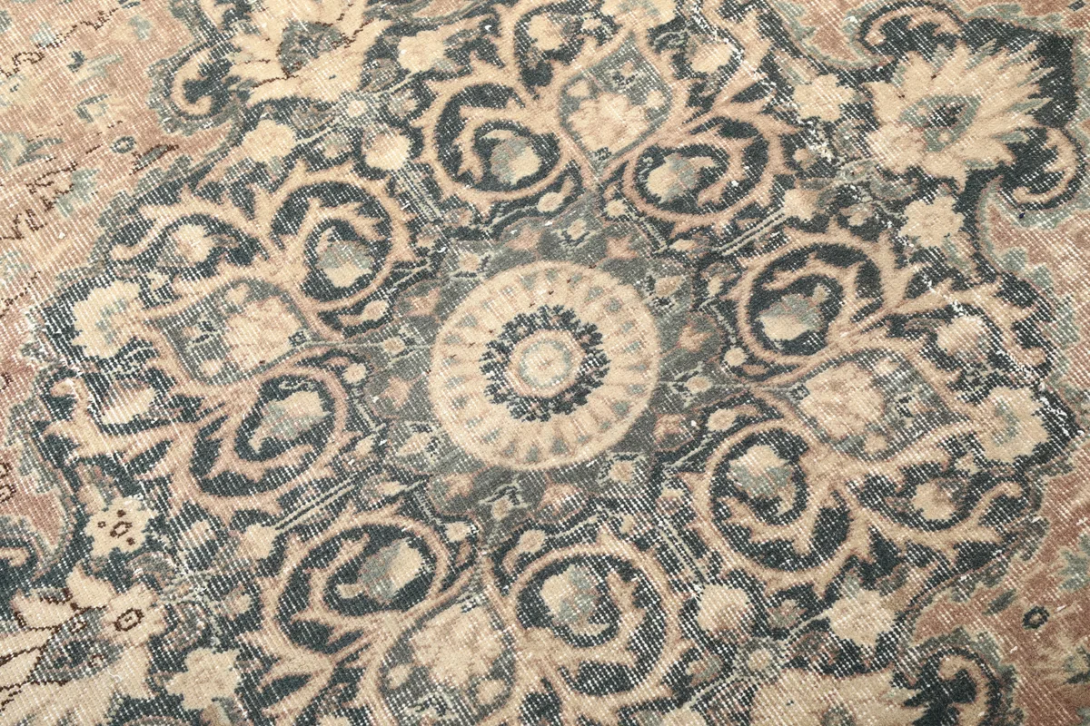 Close-up detail of the Faded Rust Medallion Anatolian Rug's central navy medallion, highlighting the intricate floral design.