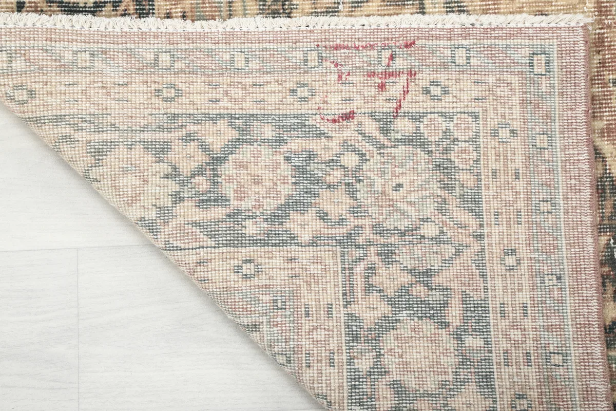 Underside view of the Faded Rust Medallion Anatolian Rug, showing the hand-knotted cotton foundation and back of the pile.