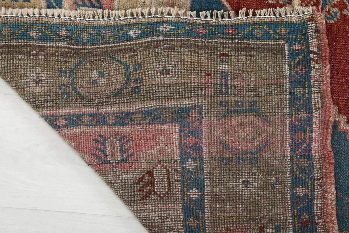 Close-up of the rug's back, showcasing the cotton foundation and hand-knotted wool pile