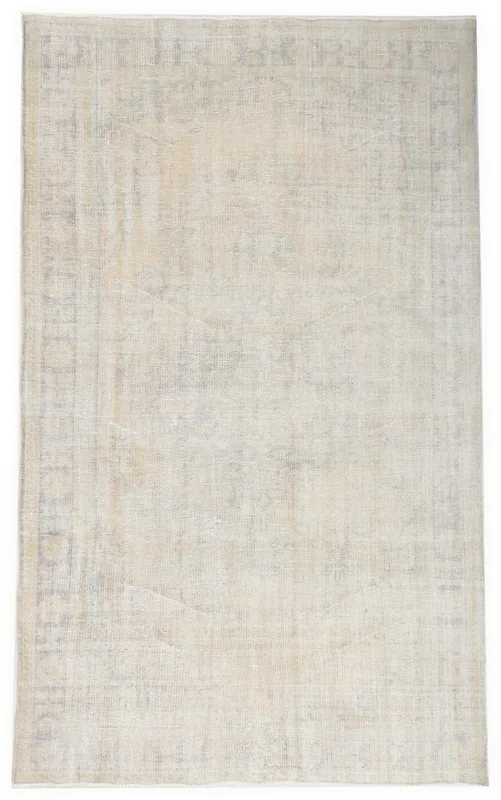 Full overhead view of the Faded Ivory Geometric Area Rug on a white background