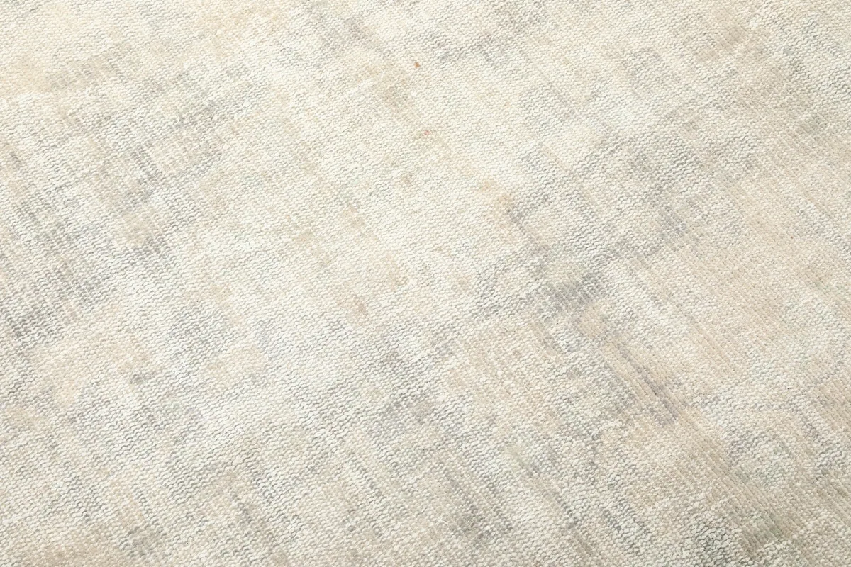 Detailed view of the low wool pile, highlighting the distressed look and color variations of the rug