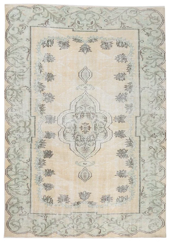 Full overhead view of the beige and green vintage Anatolian rug with a central medallion.