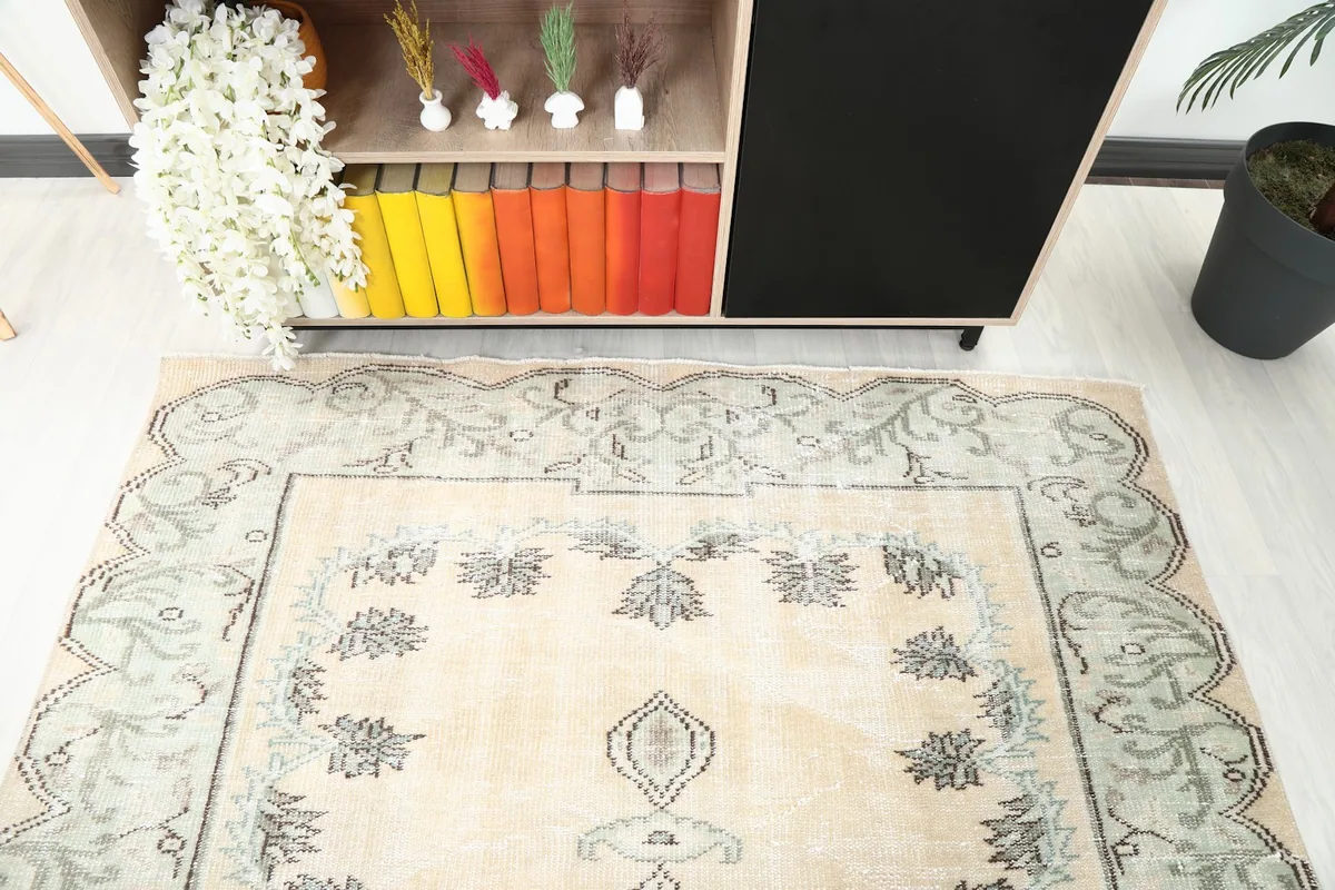 Angled detail shot of the rug's upper section, showing the border and field motifs.