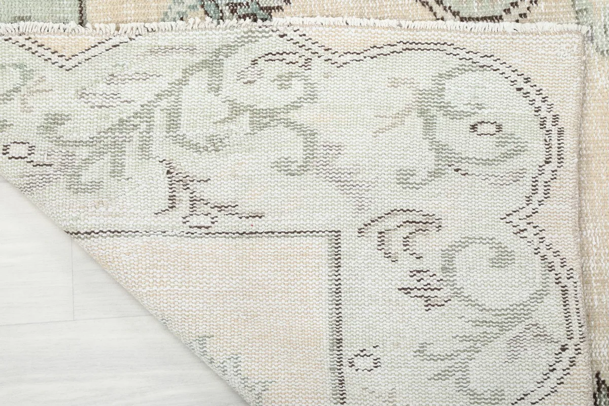 Underside view of the rug, revealing the hand-knotted cotton foundation.