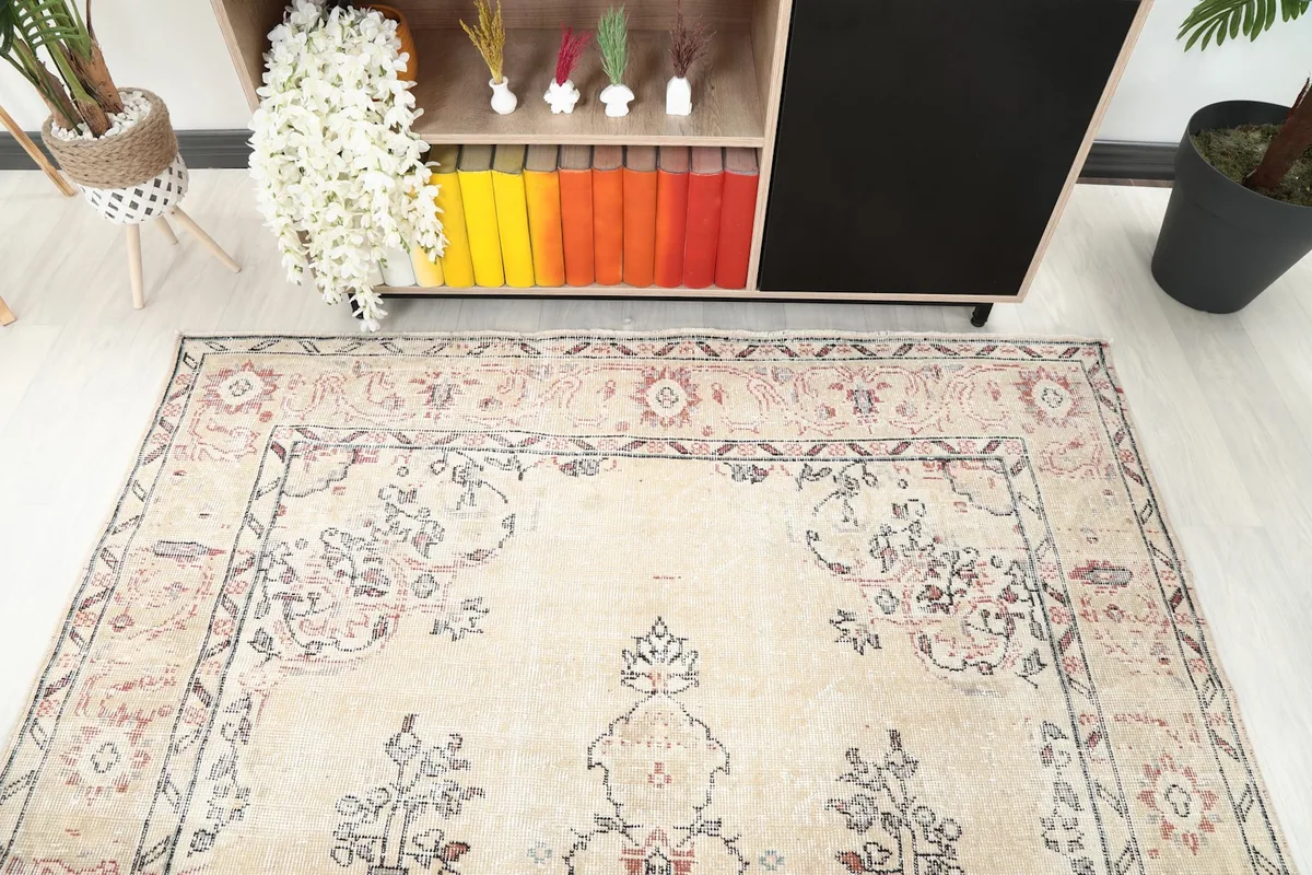 View of the rug's top half, showing the ivory field and border design