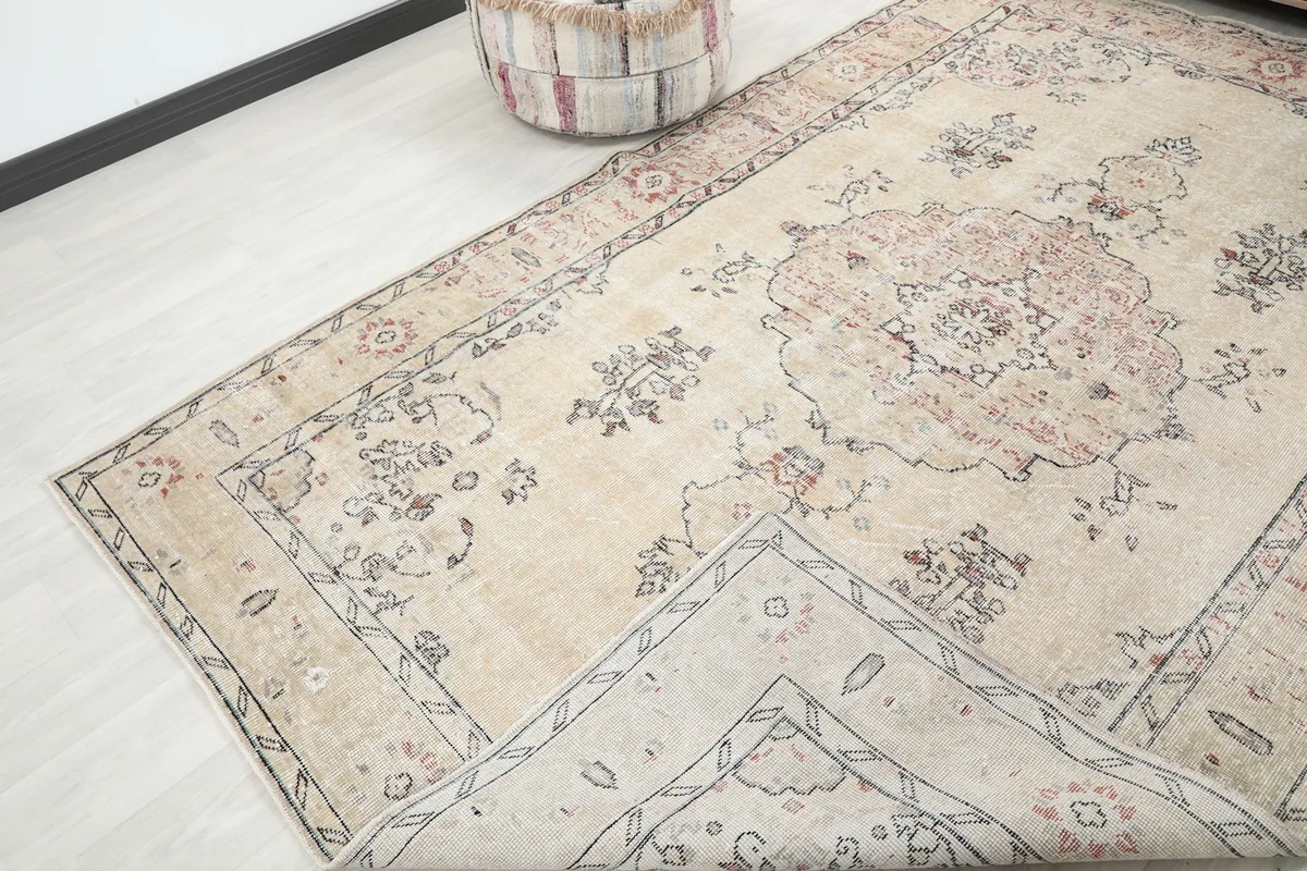 Corner of the rug folded back to reveal the cotton foundation and reverse side of the knots