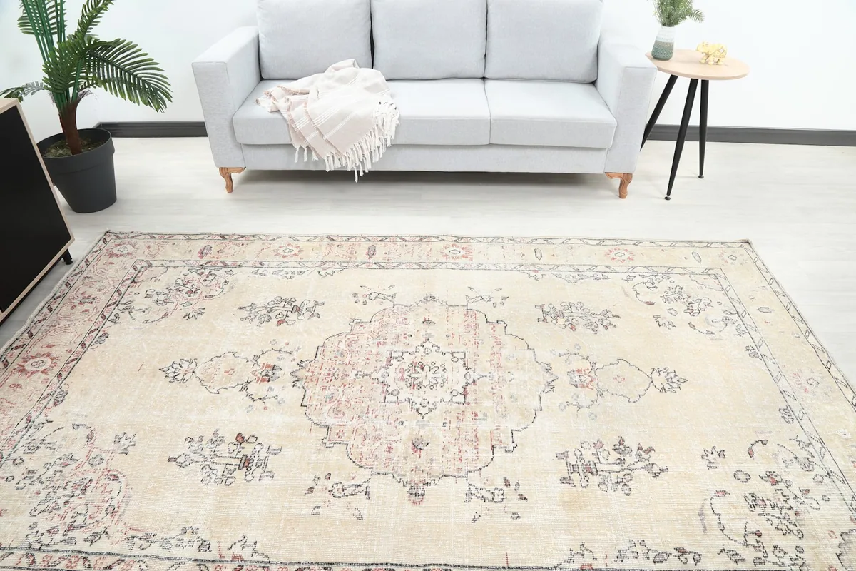 Overhead view showing the rug's central medallion and colors in a room setting