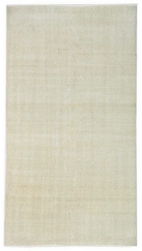 Full top view of the 3'7" x 6'9" cream distressed vintage Anatolian rug on a white background.