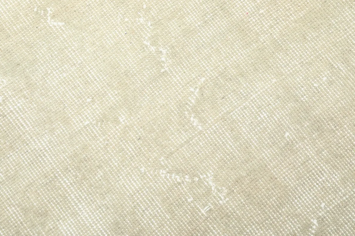 Very close view of the low wool pile, illustrating the hand-knotted weave and vintage character.