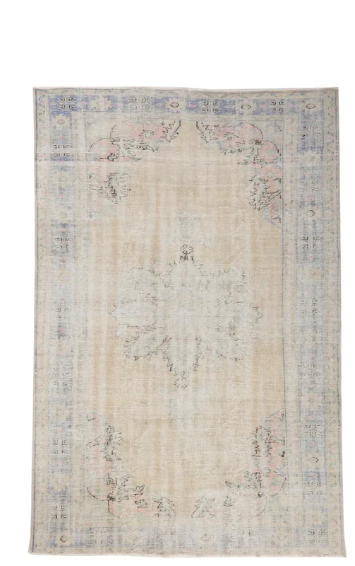 Full overhead view of the 6'7" x 9'10" vintage Anatolian rug with ivory field and blue border