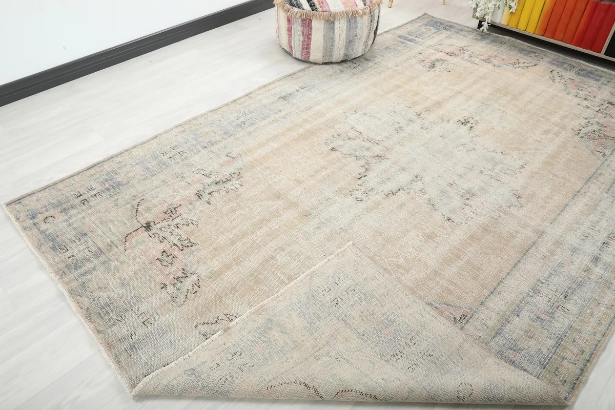 Corner of the rug folded back to show the cotton foundation and reverse side of the knotting