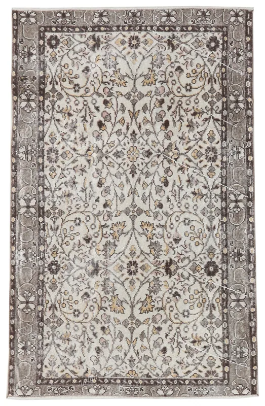 Full top view of a cream and brown vintage Anatolian rug with floral patterns