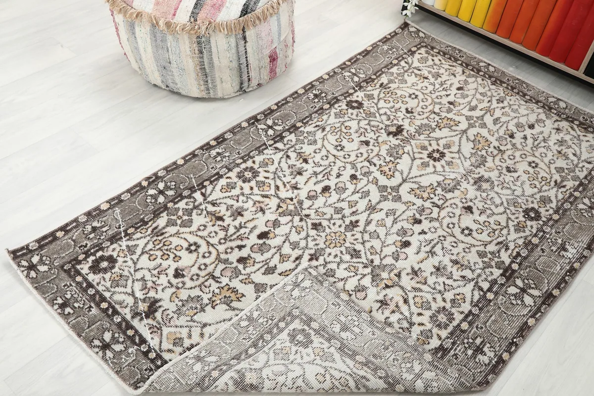 Corner of the rug folded to reveal the backside and construction
