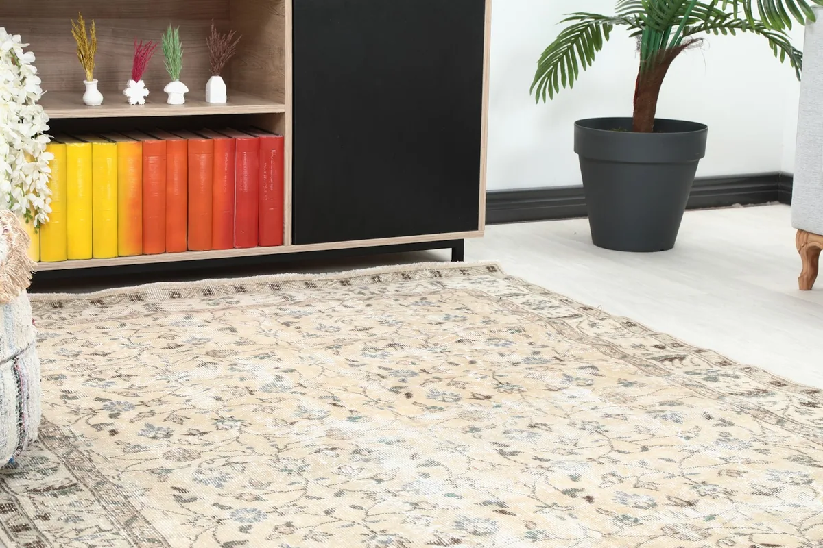 Close-up of the rug's pattern and texture in a room setting, showing subtle colors