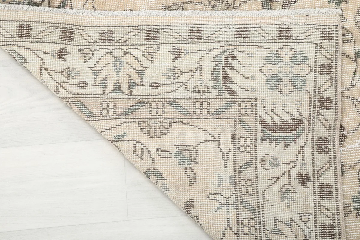 View of the back of the rug, showing the cotton foundation and hand-knotted construction
