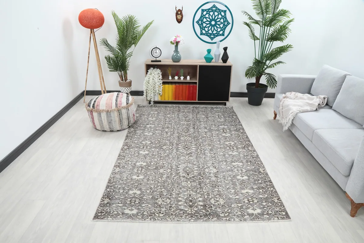 Vintage gray and ivory rug placed in a modern living room setting