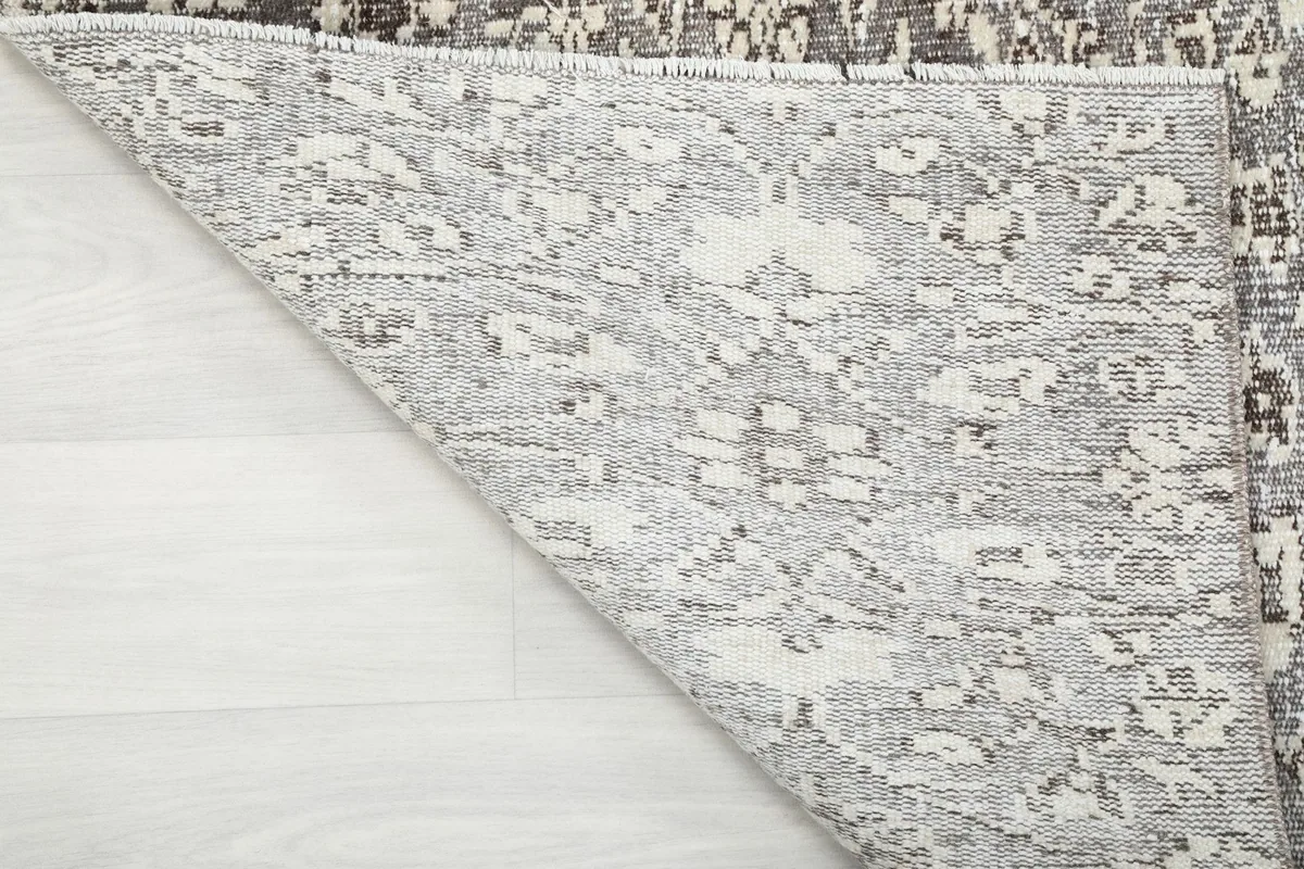 Detail of the rug's back, revealing the tight hand-knotted cotton foundation