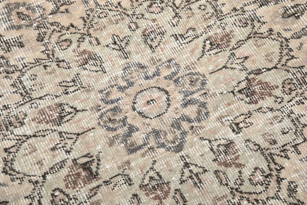 Close-up showing the low wool pile and hand-knotted texture of the rug