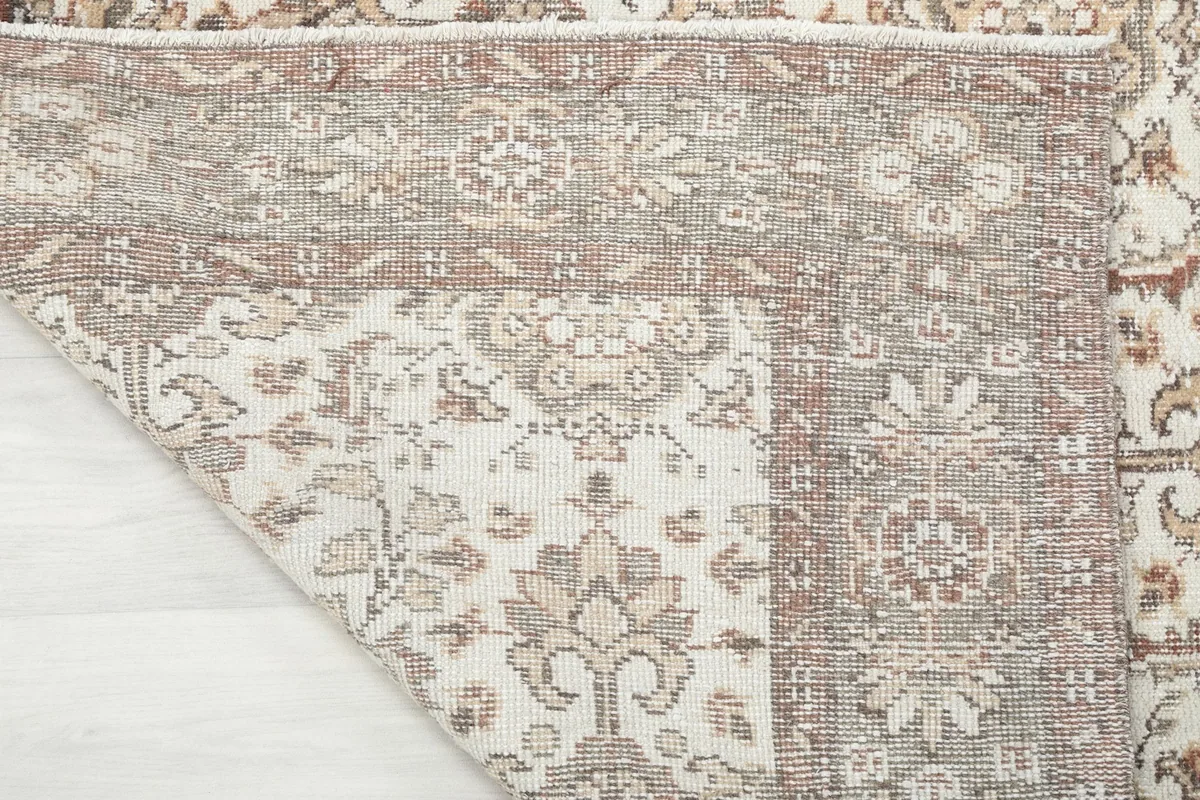 View of the rug's underside, revealing the hand-knotted wool pile on a cotton foundation