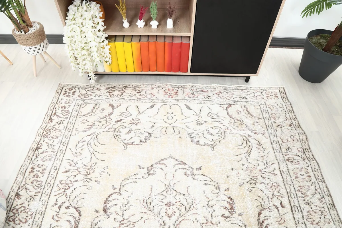 Angled view of the central medallion and floral patterns on the rug's ivory field