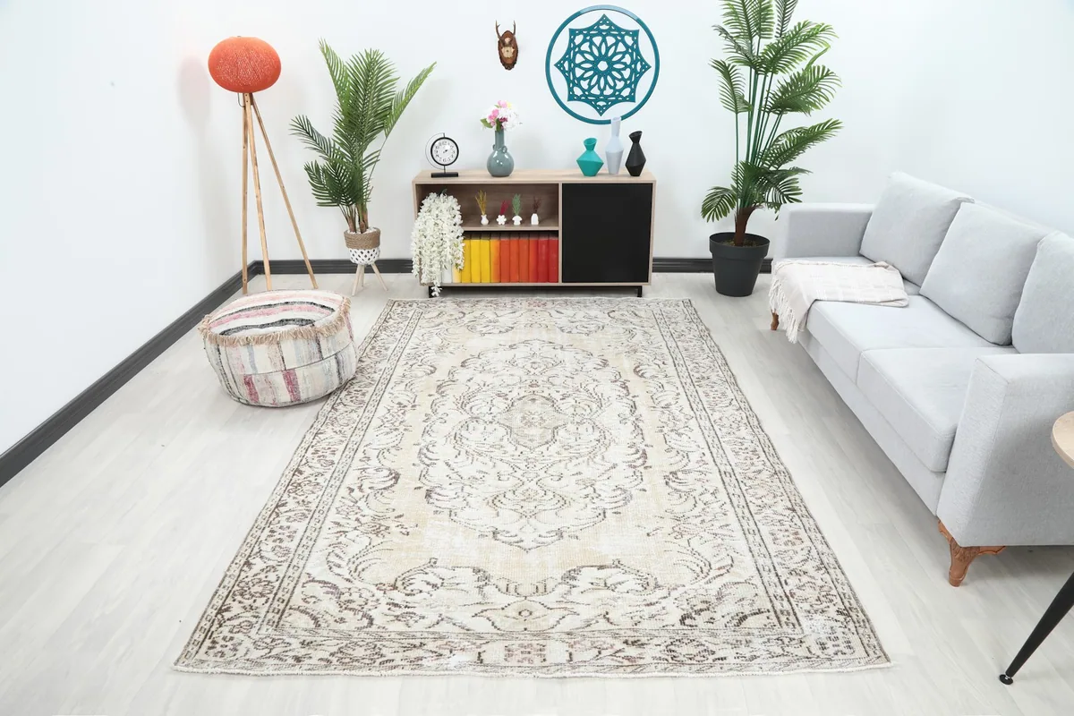 Vintage Anatolian rug in a living room setting with a light gray sofa and wooden furniture