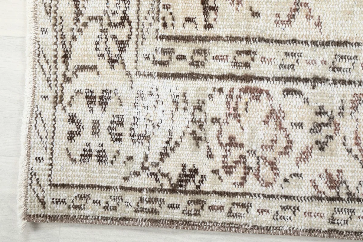 Detail of the rug's border design and corner, showing the hand-knotted texture